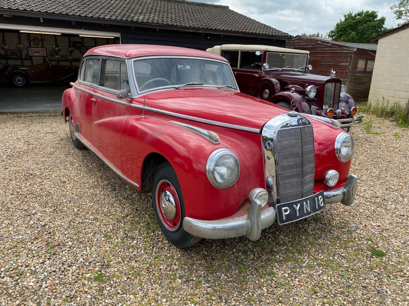 Two W189 Mercedes-Benz 300 ‘Adenauer’ saloons have emerged from the same outbuilding on a large prop